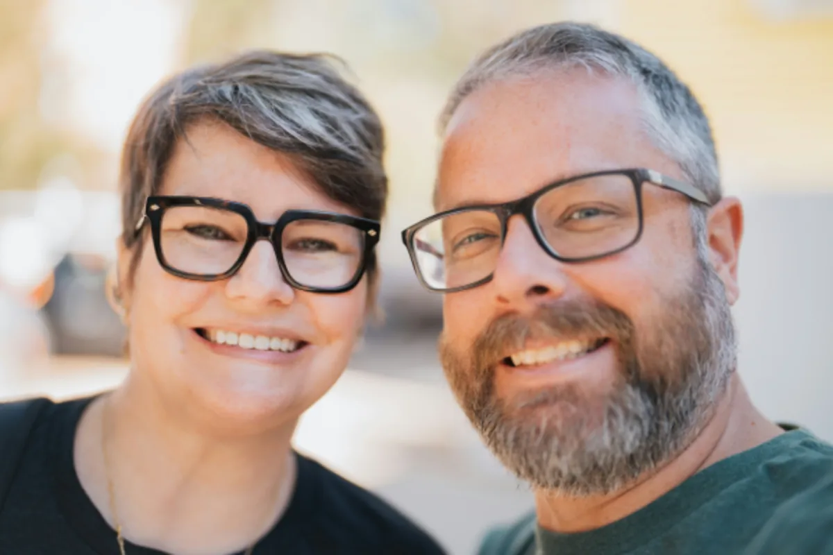 Smiling mature couple wearing glasses, confident about their Medicare coverage